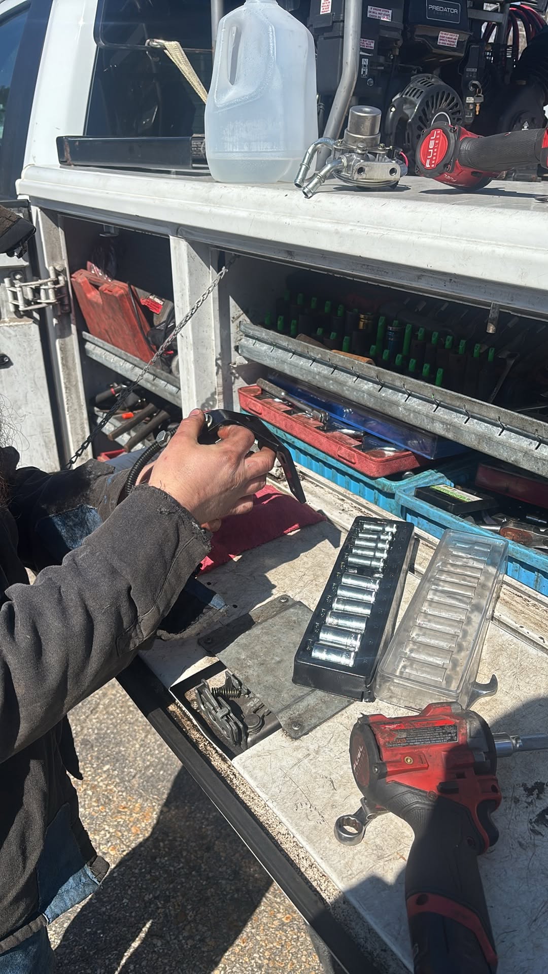 A technician using tools at the service truck during the company’s diesel filter head replacement in Hooksett